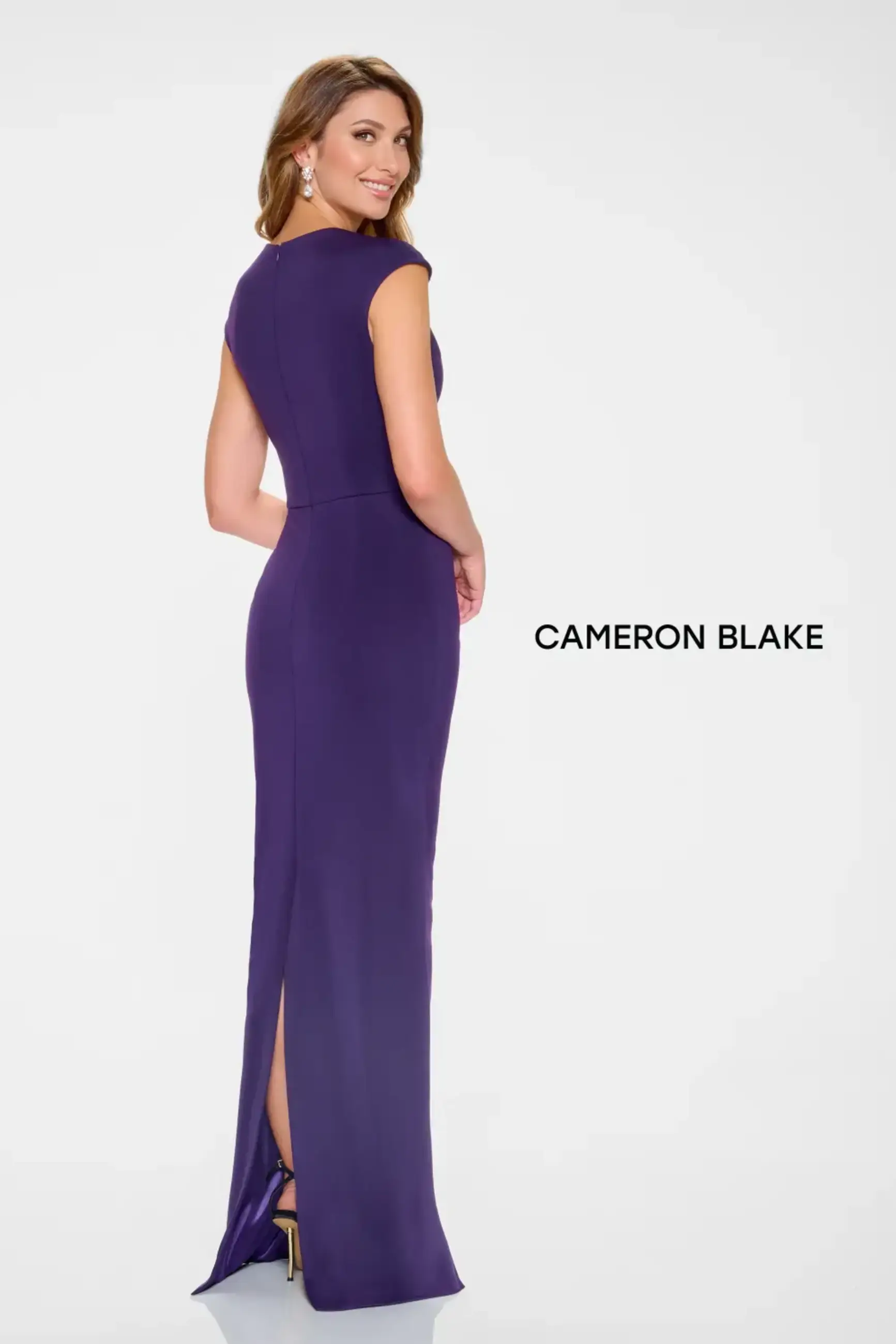 Model is wearing an evening gown with an asymmetrical neckline and cap sleeves made of stretch crepe