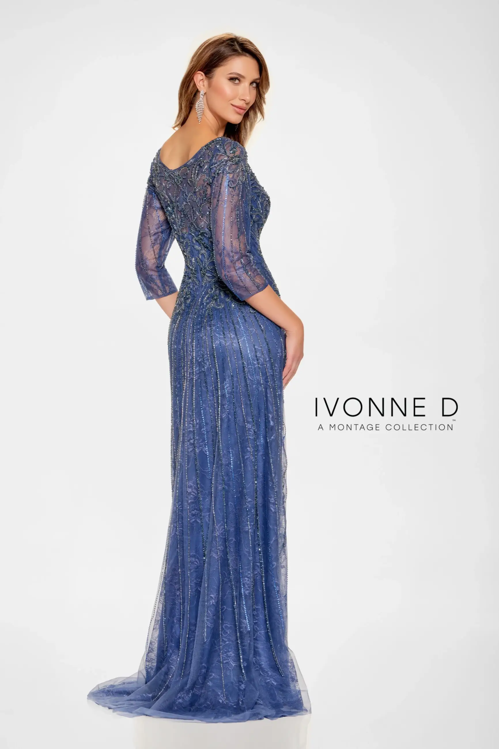 Model is wearing a fit and flare allover lace evening gown with illusion sleeves and a semi sheer back