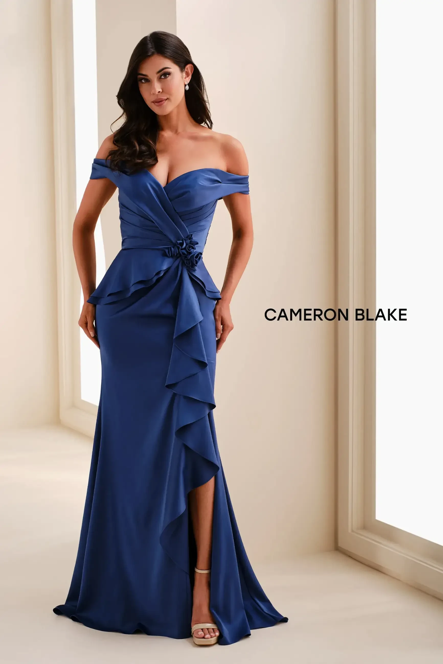 Model is wearing a mermaid sweetheart neckline evening gown with off the shoulder sleeves 