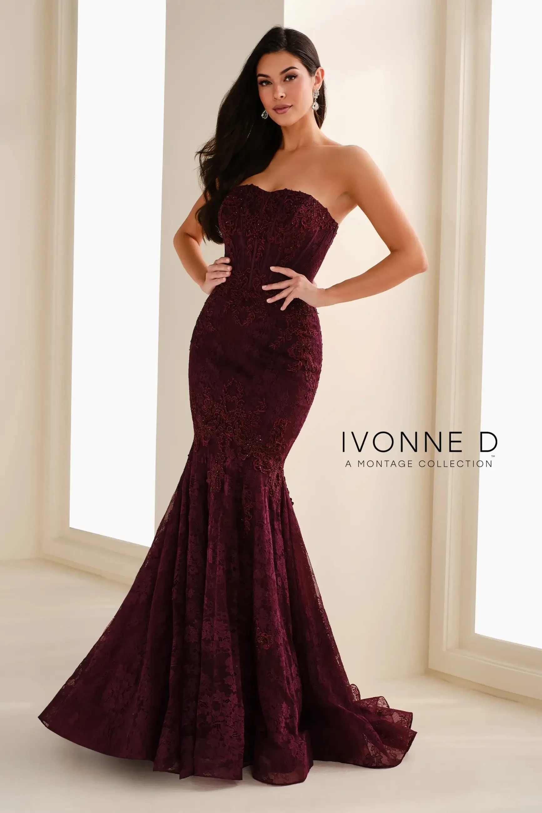 model is wearing a mermaid aubergine evening gown with detachable blouson sleeves