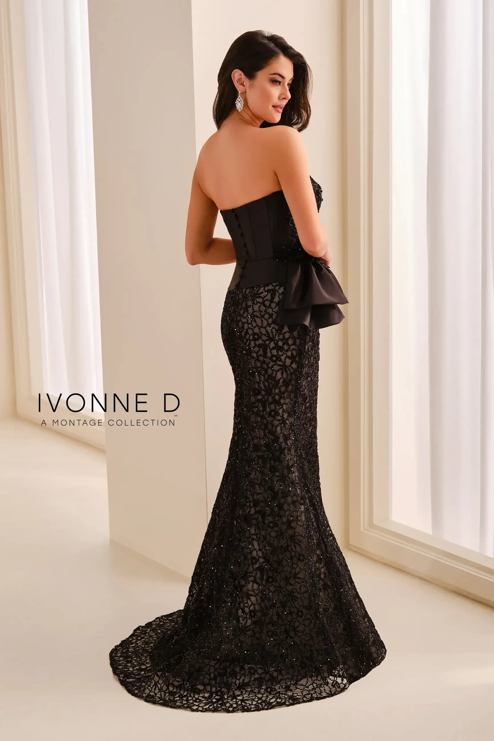 model is wearing a black strapless mothers dress