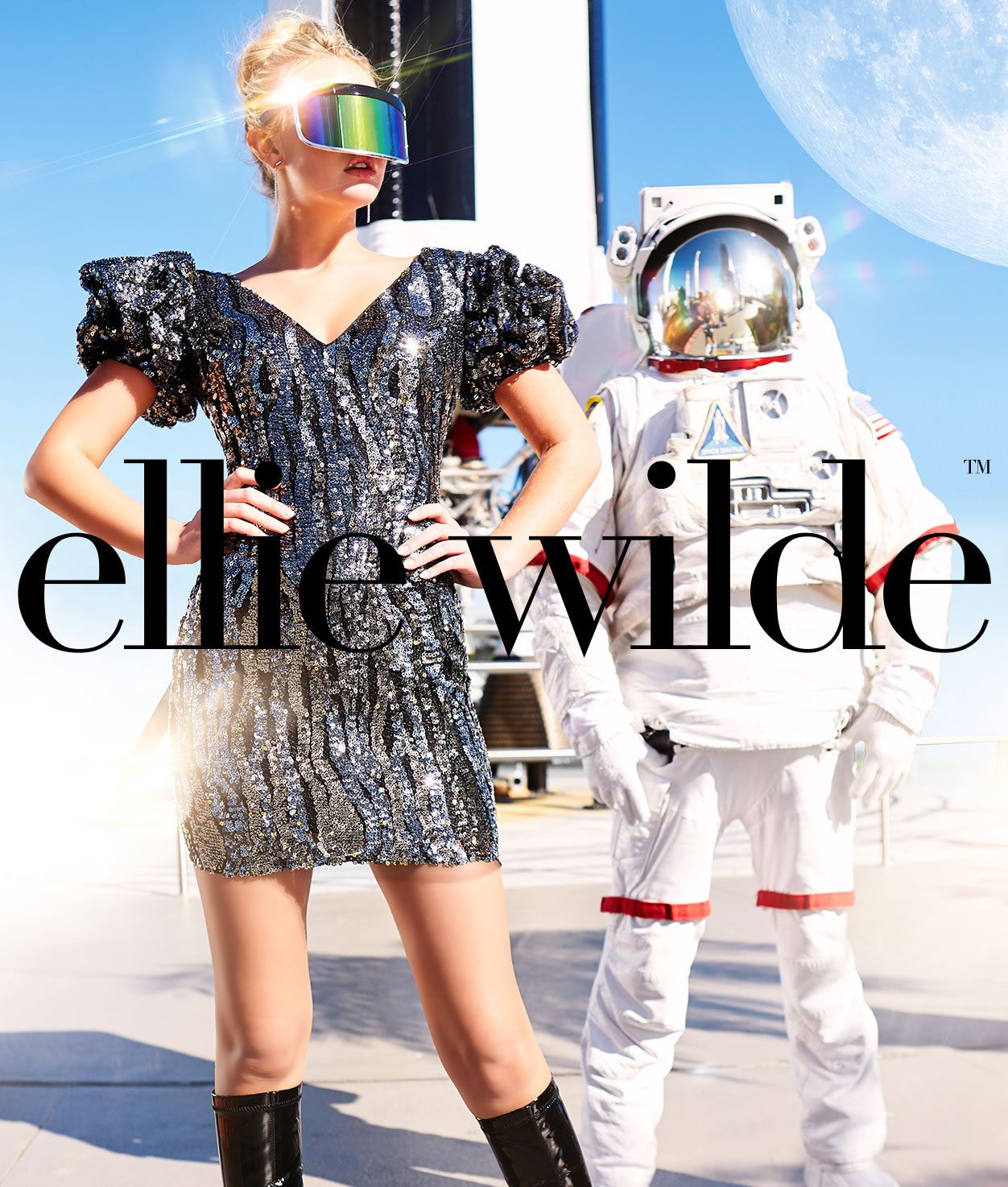 Girl in sparkly dress standing next to astronaut