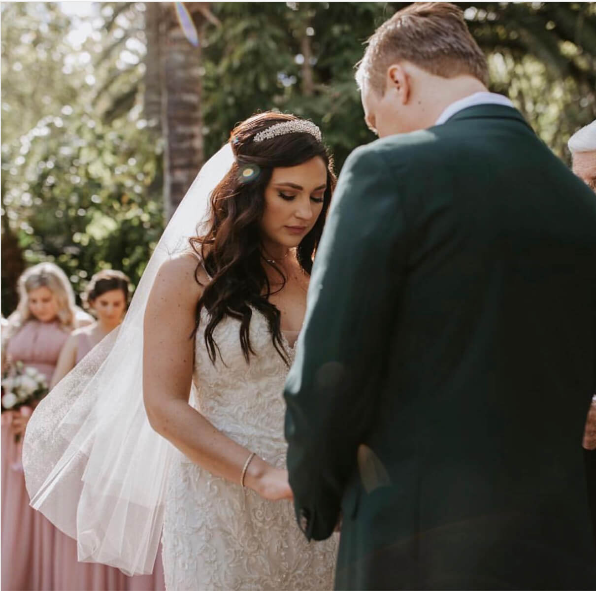 Bride and groom holding hands at the altar
