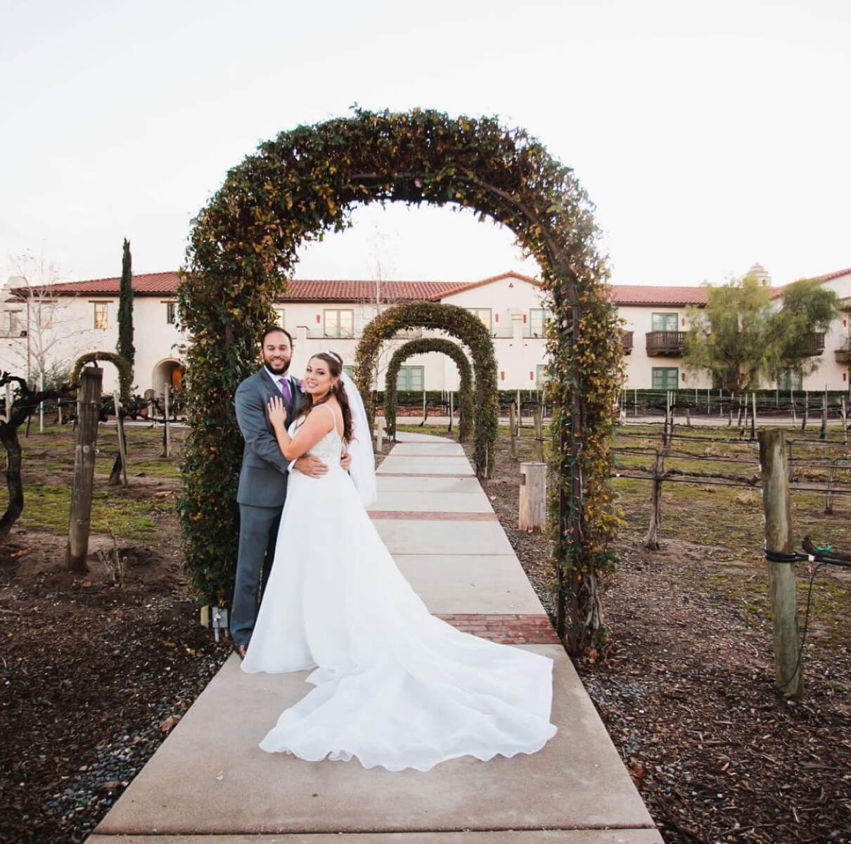 Bride and groom standing together in a garden