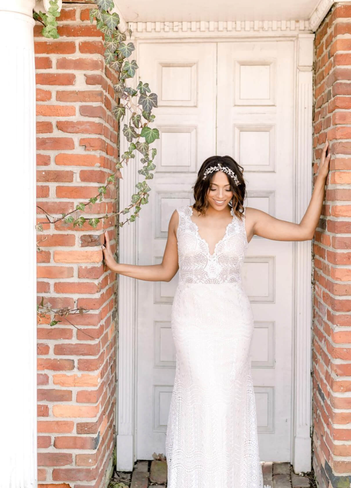 Brunette bride standing in front of doorway