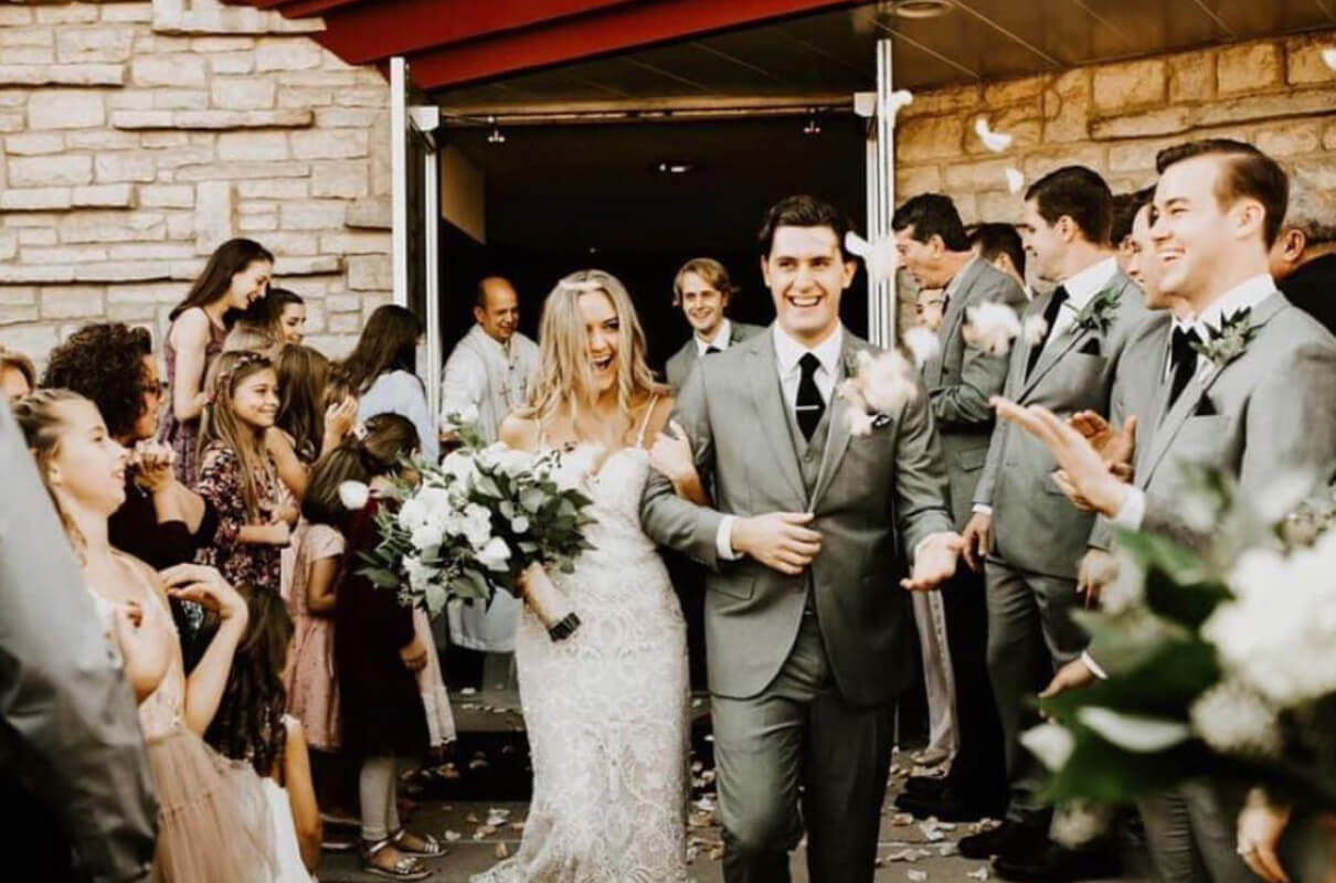 Bride and groom leaving their wedding venue